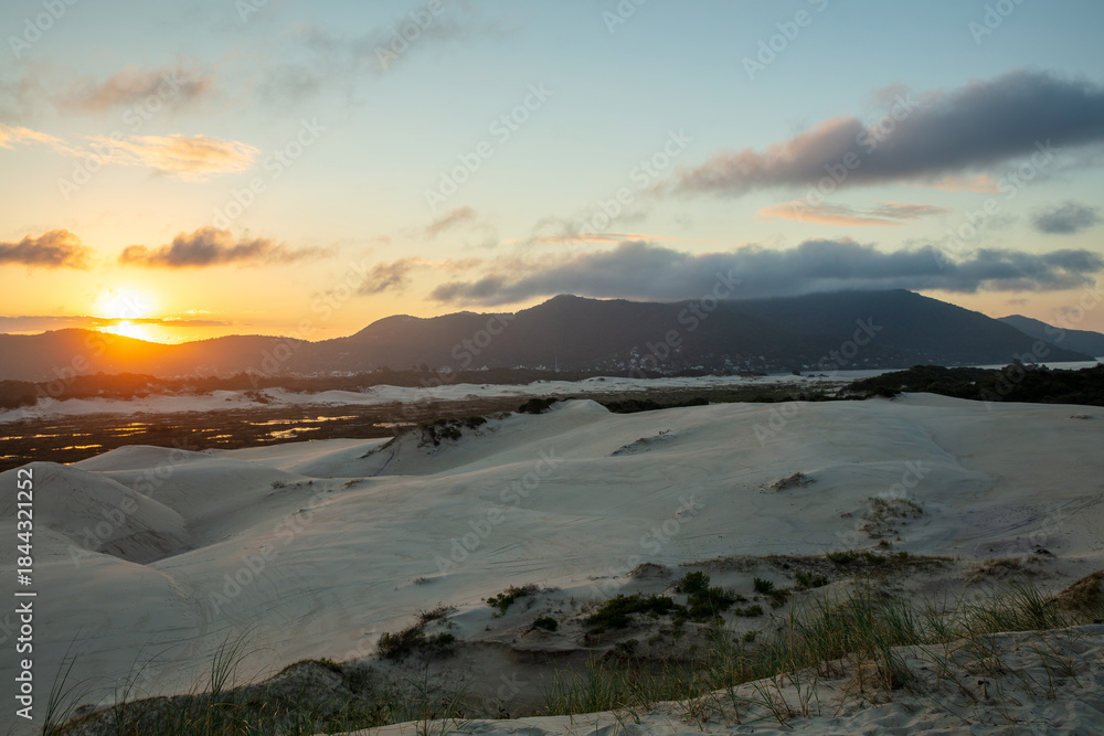 Obraz premium Panoramic view of the Joaquina dunes at sunset on Florianopolis Island, Santa Catarina, Brazil.