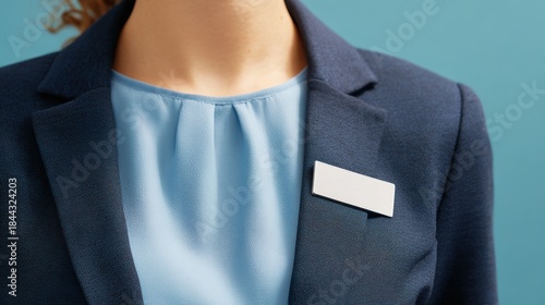 Professional attire: navy blazer, light blue blouse and blank name tag.