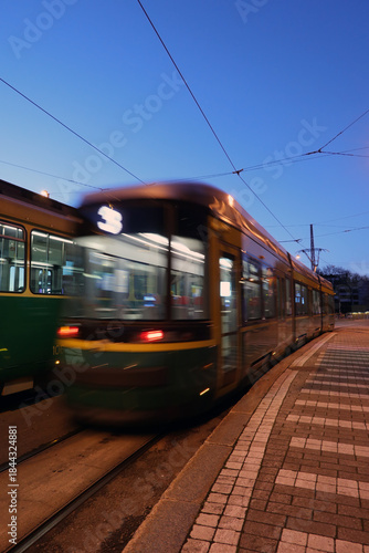 Tram Departing Tram Stop in the Evening. In-camera motion blur.