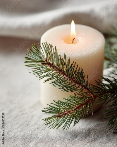 White candle with pine sprig and soft glow, close-up, rich texture, minimalism in lighting