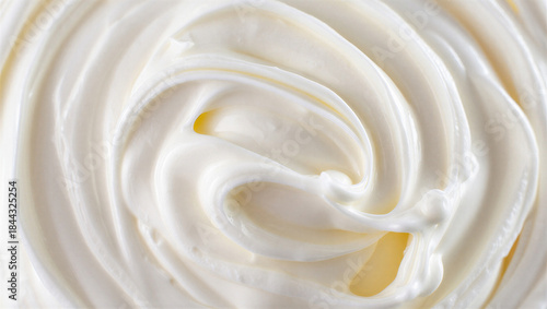 Close up of swirled white cream with golden highlights