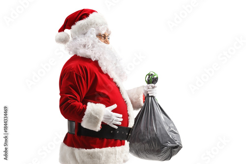 Santa claus walking and carrying a plastic bin bag