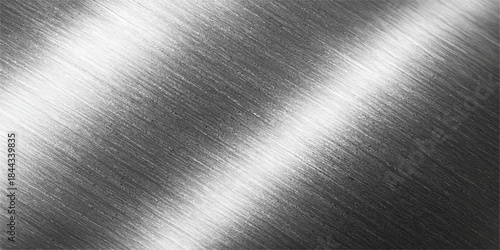 Shiny brushed metallic steel texture, reflecting light on a gray stainless aluminum surface with an industrial pattern