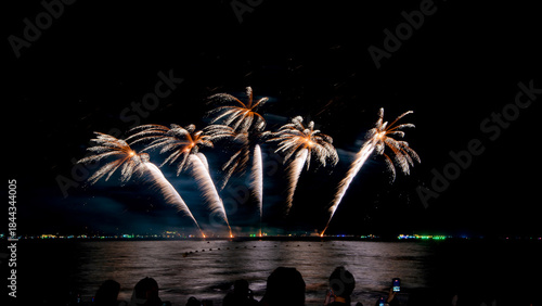 Amazing beautiful colorful firework display over sea on celebration night. Fireworks show for happy new year	