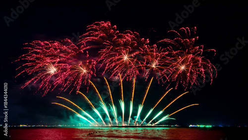 Amazing beautiful colorful firework display over sea on celebration night. Fireworks show for happy new year	