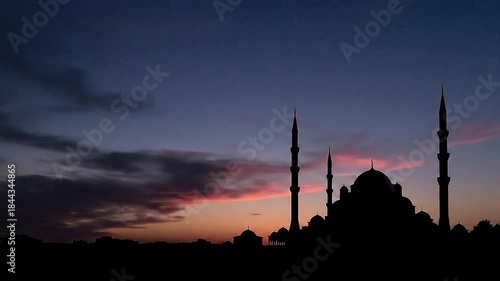 Ramadan sunset video background showing warm golden sky, slow moving clouds, distant mosque silhouette without text, peaceful fasting mood, spiritual transition from day to night, smooth cinematic loo