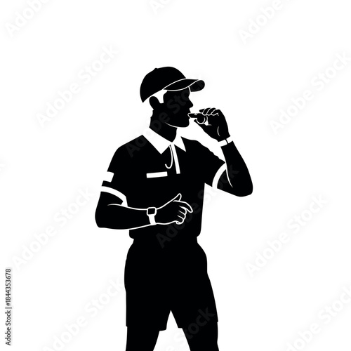 Silhouette of a male referee blowing a whistle during a sports game.