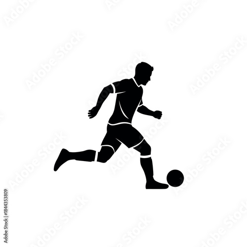 Silhouette of a soccer player kicking a ball.
