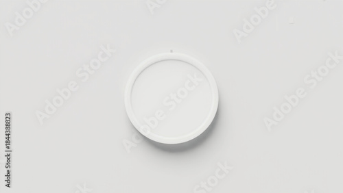 Close up of a light switch and a white pill on an empty white porcelain plate