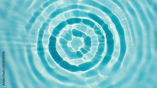 Blue swirling water ripple vortex texture and light pattern abstract design
