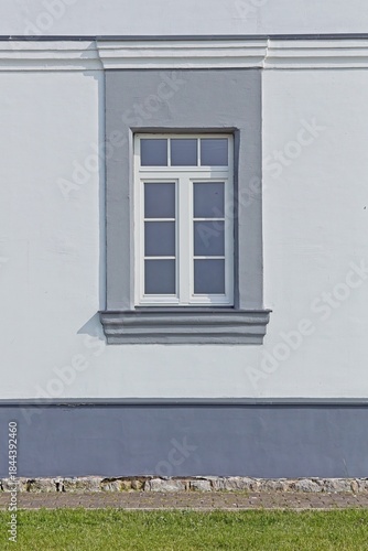 Building´s facade featuring a white double-sash, inward-opening flush casement window in sunny summer weather, Sõrve Peninsula, Saaremaa, Estonia.