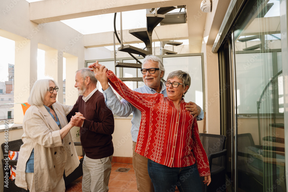 Obraz premium A man from behind has his hand on the shoulder and is holding the hand of a woman in front of him while they dance with two friends next to them and they are smiling and talking
