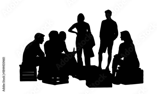 Group of young adults socializing outdoors on wooden crates.