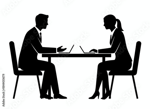 Two people working at laptops across table for collaboration teamwork meeting office coworking business partnership professional discussion branding design