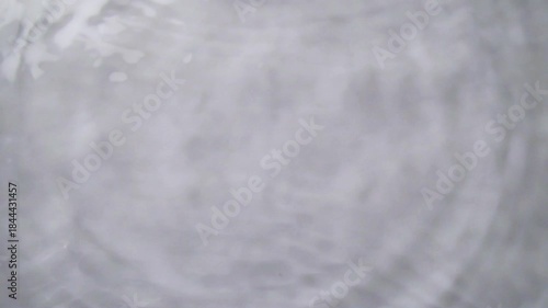 Close-up of Water Droplet Splash Creating Ripples in Slow Motion