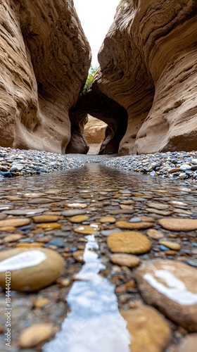 Slot Canyon Stream with Natural Arch and Pebbled Riverbed