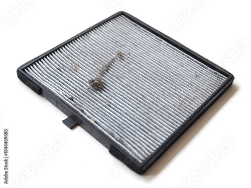 A close-up view of a worn cabin air filter, highlighting its functionality in the car air quality system. 