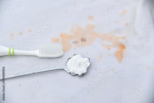 baking soda with brush for clean stain on shirt in daily life