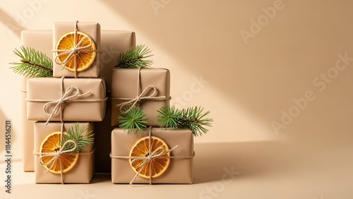Minimal eco friendly Christmas gift boxes flat lay with kraft paper, twine, dried orange and copy space

