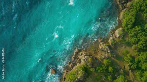 Fototapeta Naklejka Na Ścianę i Meble -  Aerial view of turquoise ocean meets lush shore