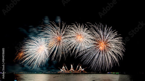 Amazing beautiful colorful firework display over sea on celebration night. Fireworks show for happy new year