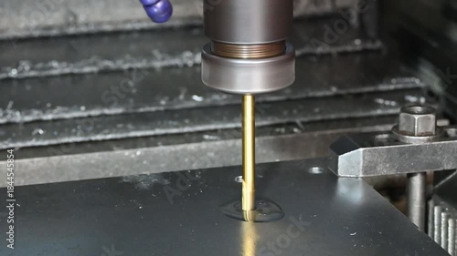 The hole reamer process the metal plate on CNC milling machine.