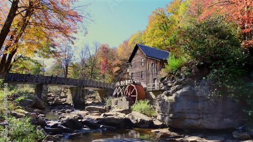 Tourists walk the bridge leading the the Glade Grist Mill, an old gristmill used to grind corn.