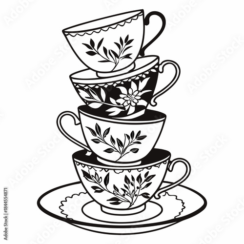 Stack of four black and white teacups with floral designs