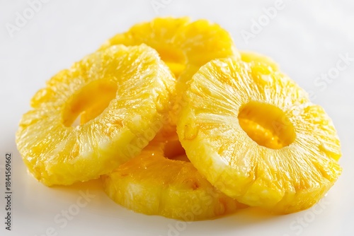 Fresh sliced pineapple rings with visible texture, juicy tone, isolated on white background.