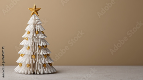 Paper christmas tree origami style gold ornament festive decoration holiday season minimalist decor beige background star topper handmade craft folded paper art Elegant paper christmas tree
