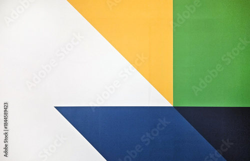 Colorful geometric shape on a background or wallpaper. Abstract of white, blue, yellow and green wall.