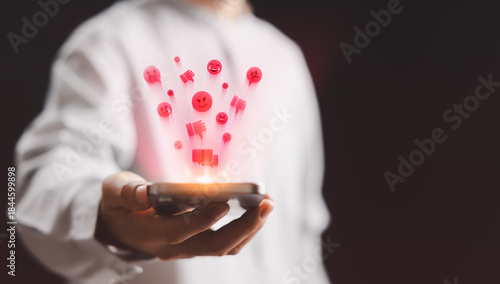 Negative reaction icons floating from a smartphone illustrate cyberbullying, online harassment, toxic behavior, highlighting the emotional impact of harmful interactions on social media platforms.