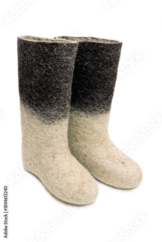 Felt boots with a light bottom and dark top on a white background