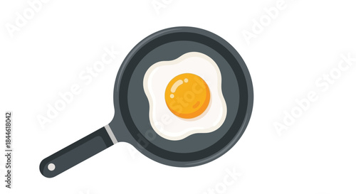 A fried egg in a dark grey frying pan viewed from above