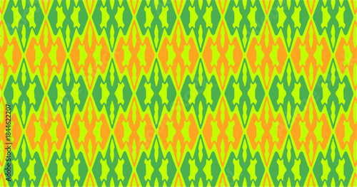 Colorful seamless zigzag and abstract ethnic pattern in green yellow and orange tones, vibrant decorative background for textile, fabric, wallpaper, and surface design.