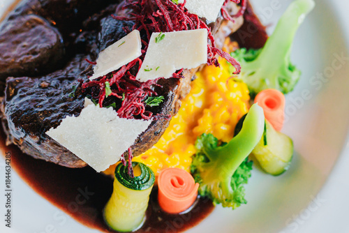 Appetizing Gourmet Dish with Tender Meat, Colorful Vegetables, and Savory Sauce Plated Elegantly for Fine Dining Experience