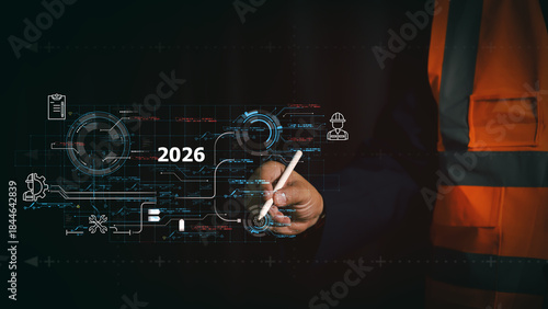 Industrial engineer using stylus on 2026 virtual interface with maintenance icons. Digital transformation in construction and smart factory technology concept for future work planning.