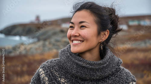 Close up outdoor portrait of smiling Eskimo woman wearing traditional clothes.