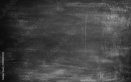 Grey textured background. Chalk rubbed out on blackboard