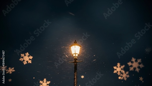 Vintage street lamp illuminates a dark winter night with decorative snowflakes.