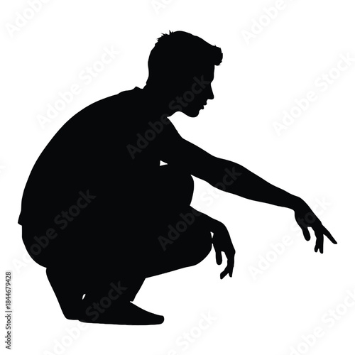 A silhouette of a man crouching and reaching downwards in profile