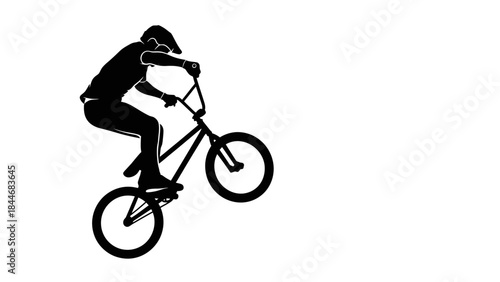 Silhouette of a cyclist riding a bicycle in a sporty mountain biking pose