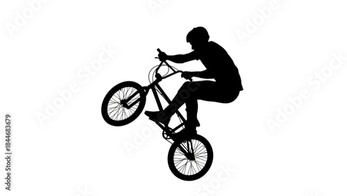 Silhouette cyclist riding a bicycle outdoors against the sky during an adventurous sporting activity