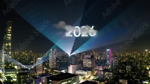 Night cityscape with projected 2020 display and light beams