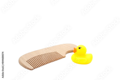 Yellow rubber duck  and Wooden hair comb isolated on white background. Children's bathing set.