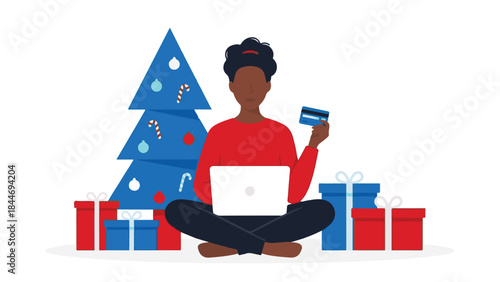 Woman shopping online for holiday gifts with credit card and laptop
