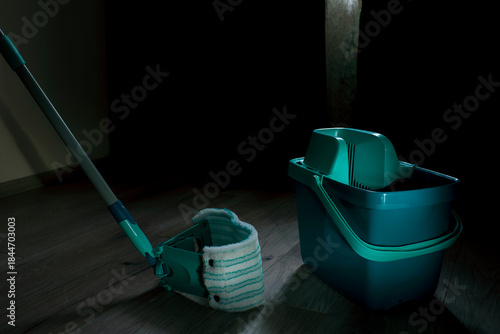 Equipment for cleaning the house in the living room.A mop and bucket are used as household cleaning tools.