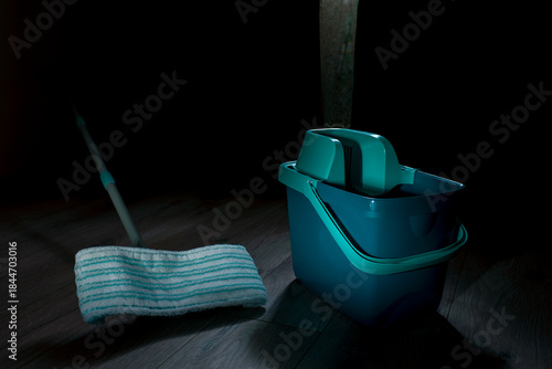 Equipment for cleaning the house in the living room.A mop and bucket are used as household cleaning tools.
