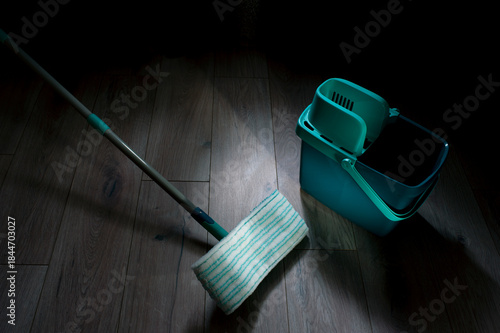 Equipment for cleaning the house in the living room.A mop and bucket are used as household cleaning tools.
