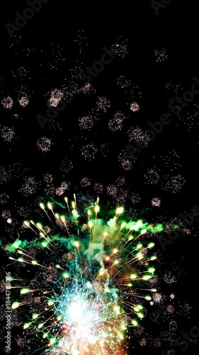 4K. loop seamless of real fireworks background golden shining fireworks with bokeh lights in the night sky. glowing fireworks show. New year's eve fireworks celebration multiple colors 